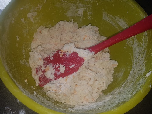 Stirring buttermilk cheddar biscuits 